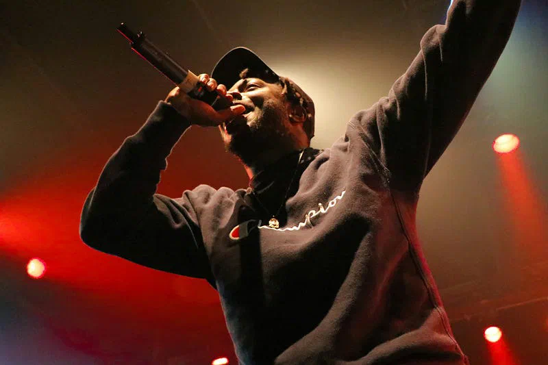 Performer holding a microphone on stage.