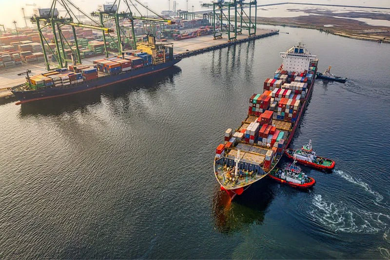 Container ships and port cranes seen from above.